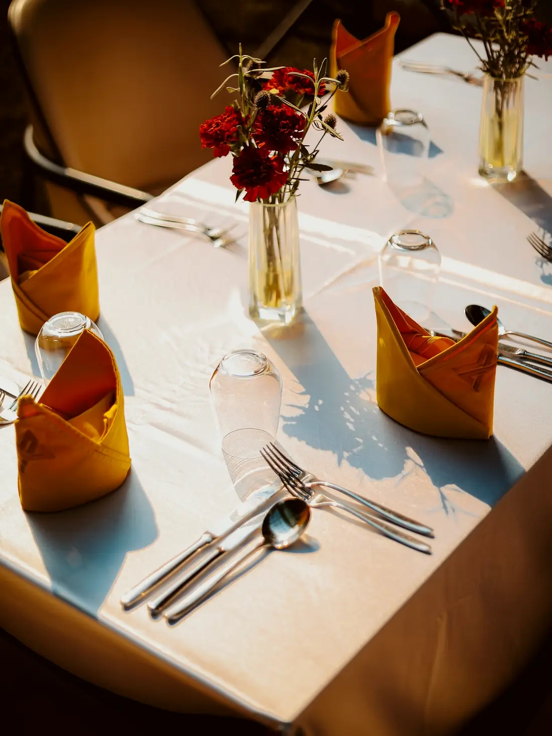 A table set for a celebration with red roses